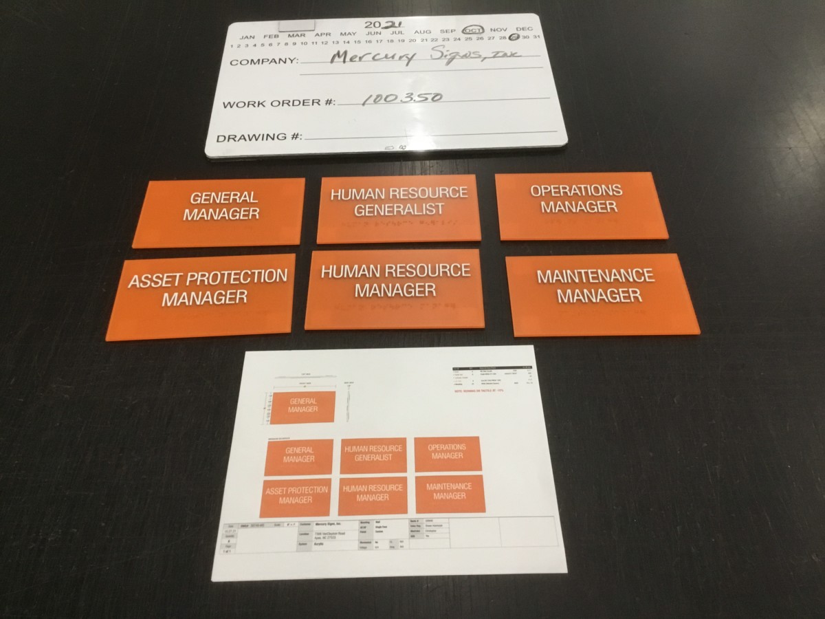 Frampton Construction ADA Room ID Signs | Mercury Signs, Inc. Orange office door signs with white text showing job titles, illustrating different custom door signs used in workplaces.