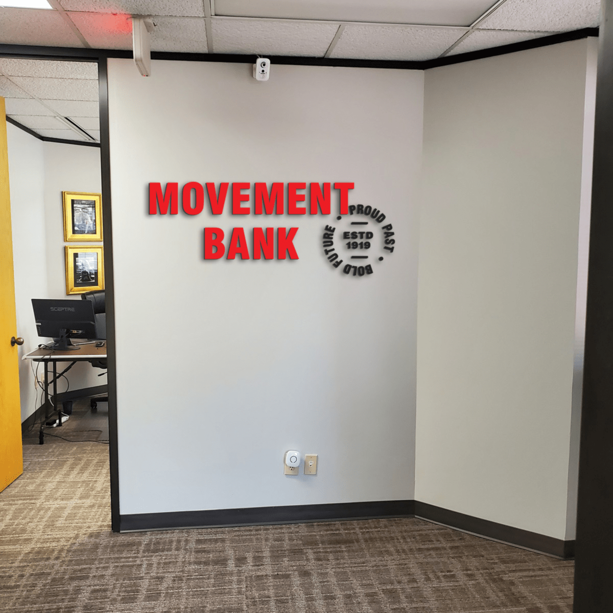 Movement Bank Lobby Sign Proof 01 | Mercury Signs, Inc. Stylish custom lobby signs in a modern office, creating a professional and inviting atmosphere for clients and visitors.