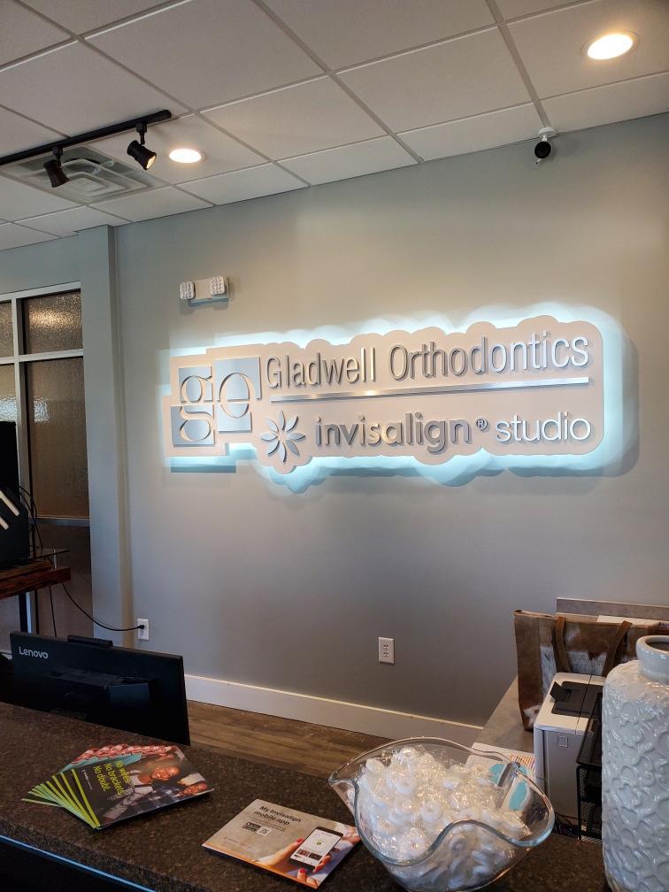 gladwellortho_interior_haloled03 | Mercury Signs, Inc. Back-lit signs glowing brightly inside a business lobby, enhancing visibility and attracting customer attention.
